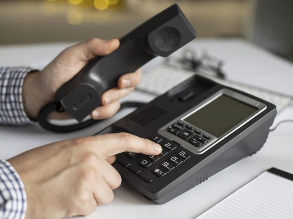 close-up-businessman-dialling-phone-number